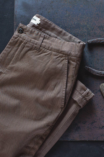 A pair of Foundation Pants folded on a black background.