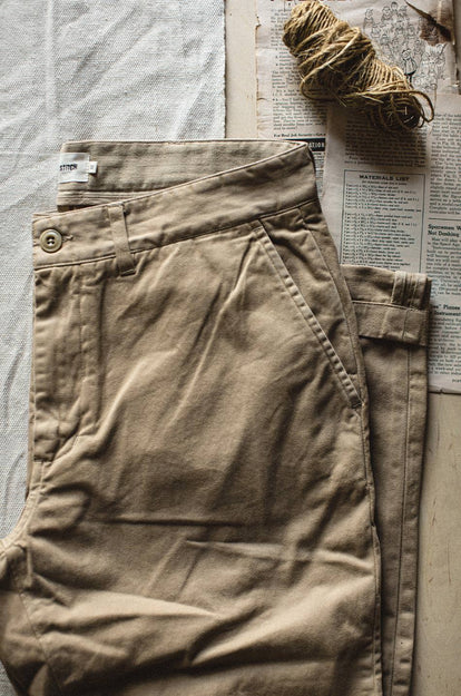 A pair of Foundation Pants folded on a black background.