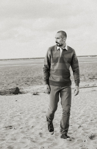 fit model walking wearing The Rugby Shirt in Faded Brick Stripe