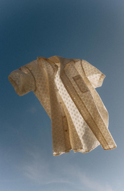 editorial image of The Short Sleeve Hawthorne in Vintage White Embroidered Eyelet in the sky