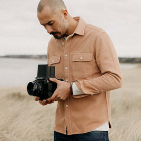 fit model posing in The Ledge Shirt in Dusty Coral Twill