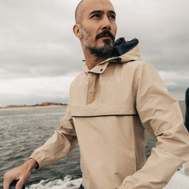 fit model posing on a boat wearing The Chapman Anorak in Light Khaki