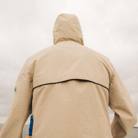 fit model showing off the back of The Chapman Anorak in Light Khaki
