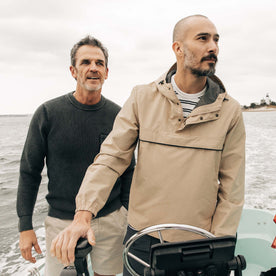 fit model driving a boat wearing The Chapman Anorak in Light Khaki