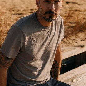 fit model sitting wearing The Cotton Hemp Tee in Steeple Grey