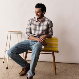 fit model sitting wearing The Craftsman Shirt in Sky Shadow Plaid