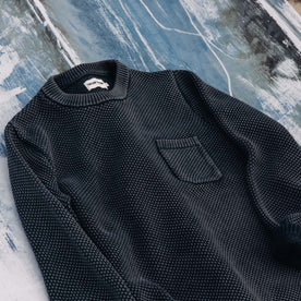 The Crawford Crew Sweater in Washed Asphalt on the hull of a boat