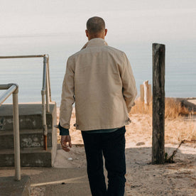 fit model walking wearing The Flint Jacket in Light Khaki Broken Twill