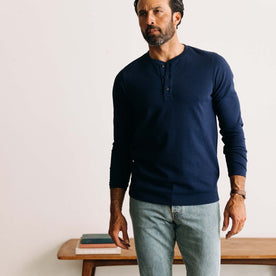 fit model walking wearing The Heavy Bag Henley in Navy