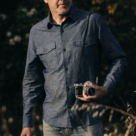 fit model holding a camera in The Point Shirt in Indigo Slub