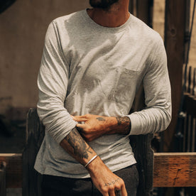 fit model adjusting sleeves on The Cotton Hemp Long Sleeve Tee in Heather Grey