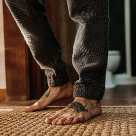 fit model wearing The Apres Pant in Charcoal Sashiko, standing on rug