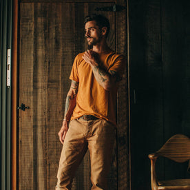 Fit Model wearing tee shirt in front of wood door
