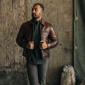 fit model sitting on a motorcycle in The Moto Jacket in Espresso Steerhide