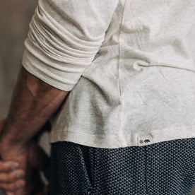 fit model showing the hem on The Cotton Hemp Long Sleeve Tee in Heathered Oat