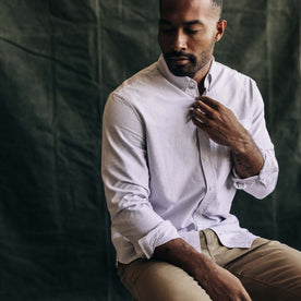 fit model sitting in The Jack in Burgundy University Stripe Oxford