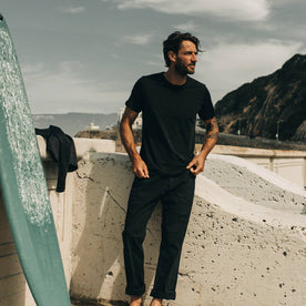 fit model standing wearing The Merino Tee in Heather Black